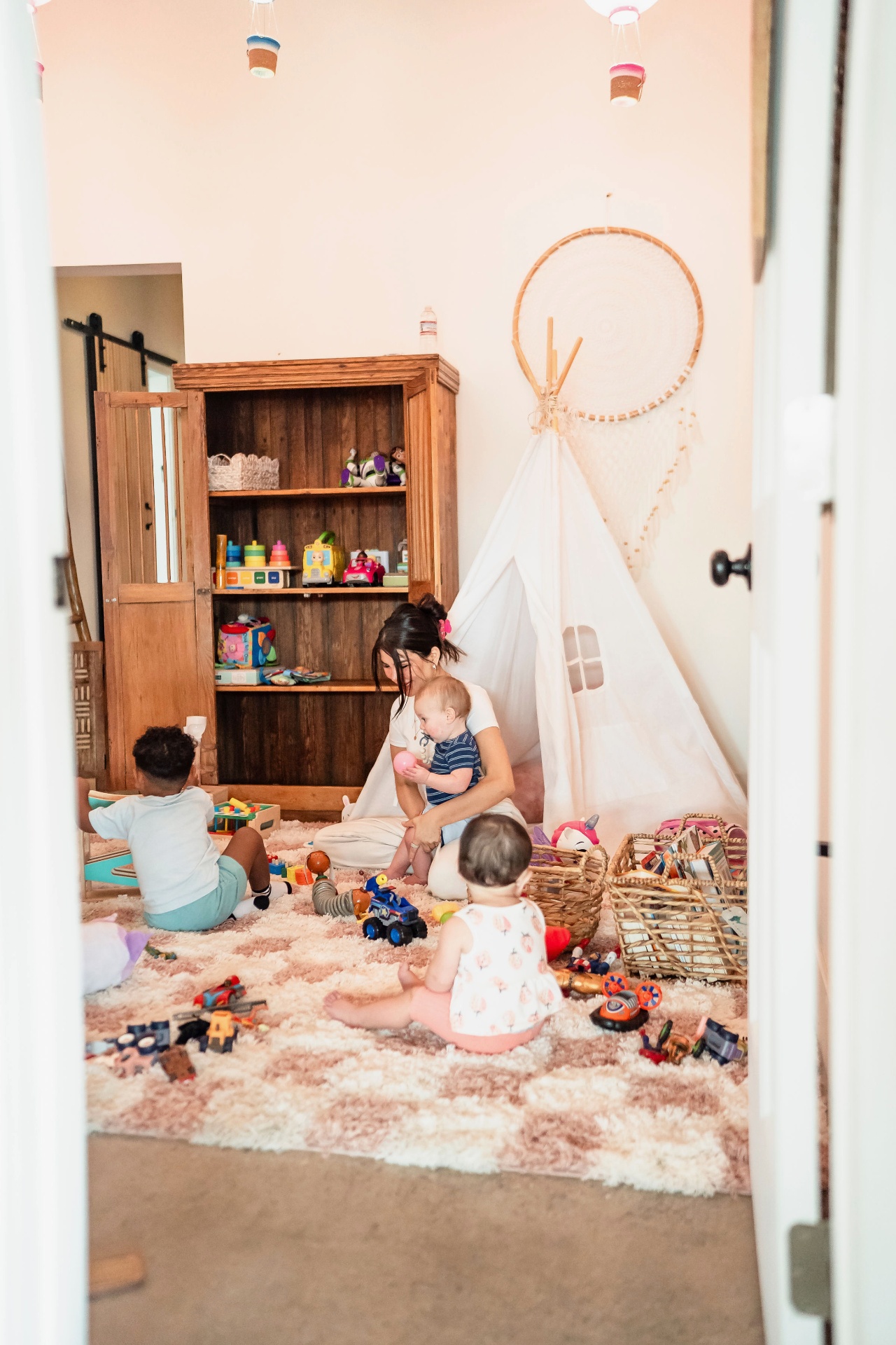 PWRGRLS Kids Club — kids playing with caregiver in a warm, toy-filled playroom